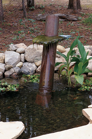 
Rich made a fountain out of a piece of well casing and granite left over from the bathroom backsplash.
